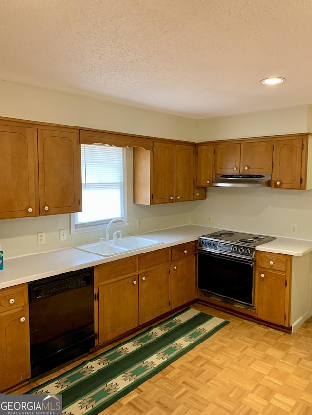 kitchen with range with electric stovetop, dishwasher, sink, light parquet floors, and a textured ceiling