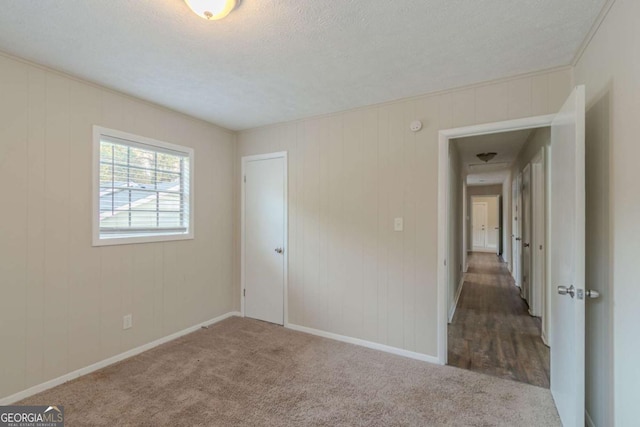 spare room with carpet flooring and a textured ceiling