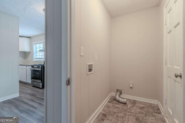 laundry area with hookup for a washing machine, light hardwood / wood-style flooring, and wooden walls