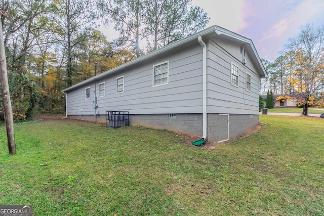 view of property exterior with a lawn