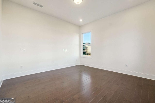 unfurnished room with dark hardwood / wood-style floors