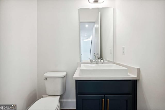 bathroom featuring vanity and toilet