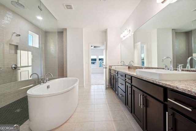 bathroom with tile patterned floors, vanity, and a bath