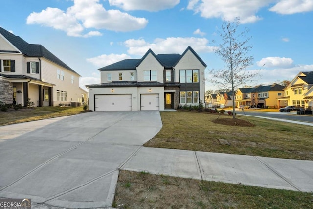 view of front of house featuring a garage and a front lawn