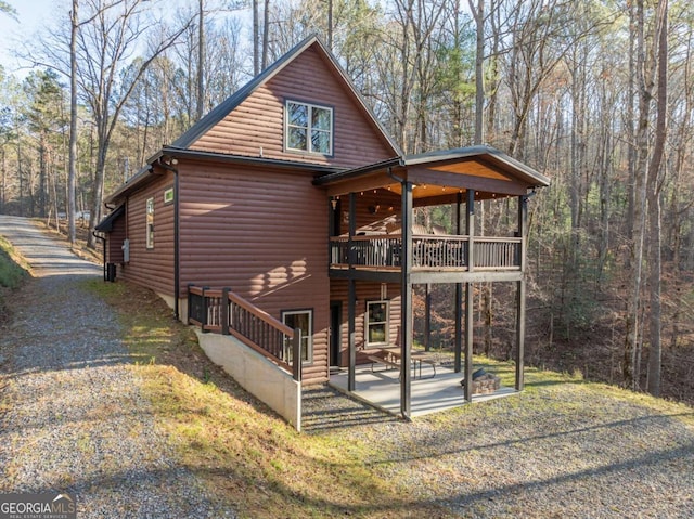 rear view of property with a patio area and a balcony