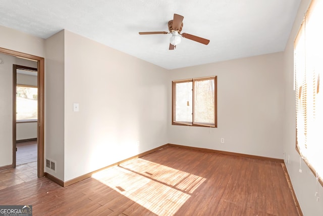 empty room featuring hardwood / wood-style flooring and ceiling fan