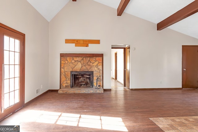 unfurnished living room with hardwood / wood-style flooring, a stone fireplace, beamed ceiling, and high vaulted ceiling