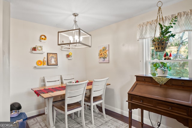 dining area with a chandelier and light hardwood / wood-style flooring