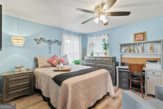 bedroom with ceiling fan and light hardwood / wood-style floors