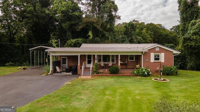 view of front facade with a carport, covered porch, and a front yard