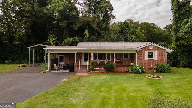 131 Logan Cir, Ellijay, GA 30540 - view of front of property featuring asphalt driveway, covered porch, a front yard, brick siding, and a metal roof