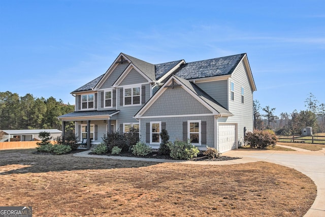 view of front facade featuring a porch and a garage