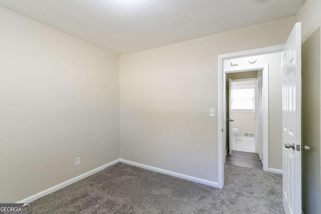 unfurnished room with light carpet