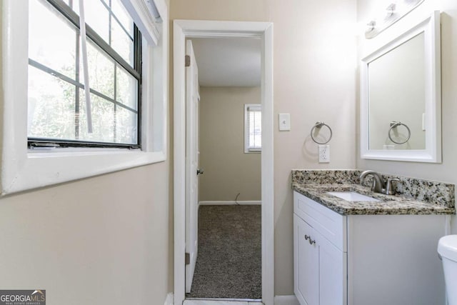 bathroom featuring vanity and toilet