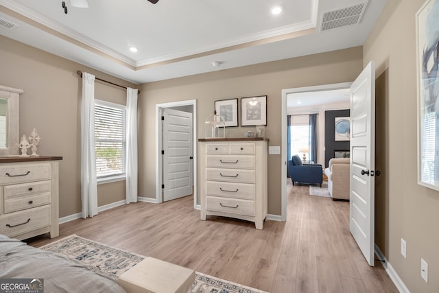 bedroom featuring multiple windows, crown molding, light hardwood / wood-style flooring, and ceiling fan