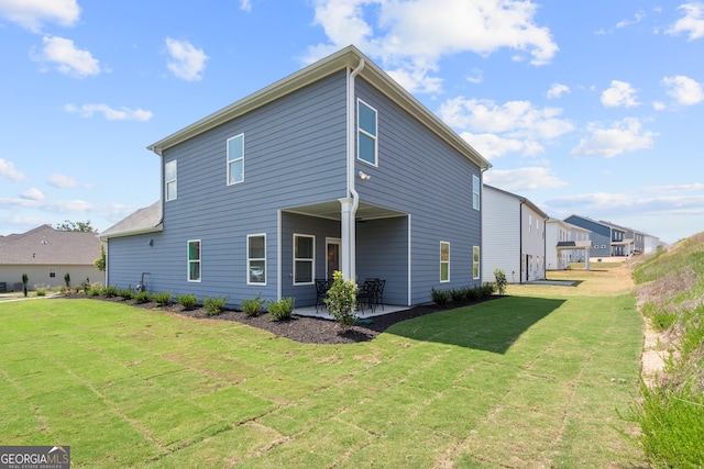 rear view of property with a lawn and a patio area