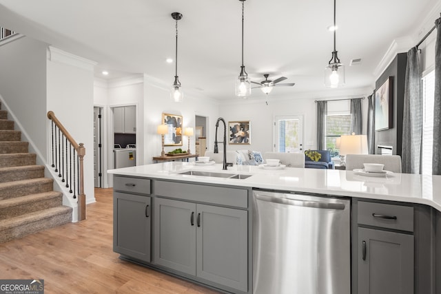 kitchen with gray cabinetry, crown molding, sink, light hardwood / wood-style flooring, and stainless steel dishwasher