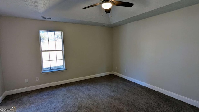 carpeted spare room with a textured ceiling and ceiling fan