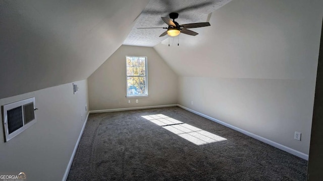 bonus room featuring a textured ceiling, ceiling fan, carpet, and lofted ceiling