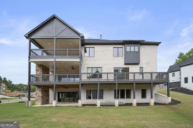 back of property with a yard, a patio, and a wooden deck