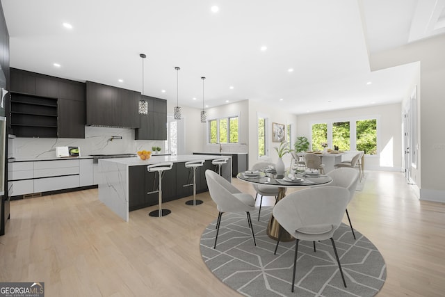 dining area featuring a healthy amount of sunlight and light hardwood / wood-style floors