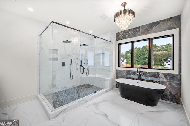 bathroom with independent shower and bath, tile walls, and a notable chandelier