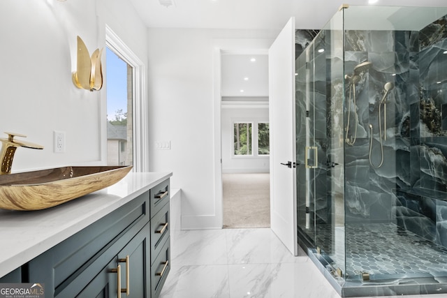 bathroom with vanity and a shower with door