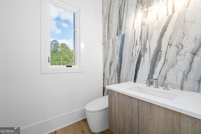 bathroom with vanity, hardwood / wood-style flooring, and toilet