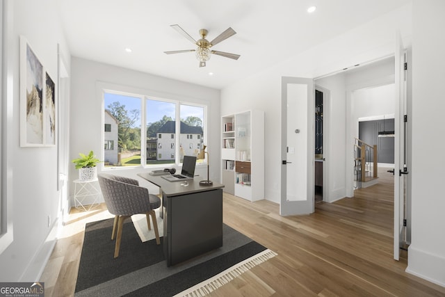 office space featuring ceiling fan, french doors, and light hardwood / wood-style floors