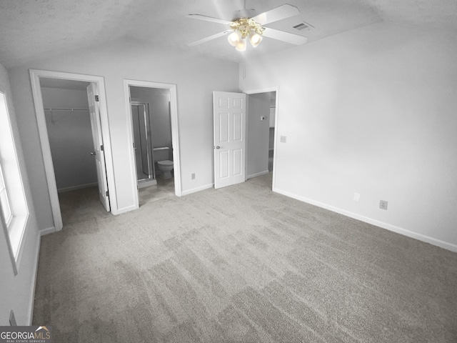 4279 Orchard Grv, Stone Mountain, GA 30083 - unfurnished bedroom with lofted ceiling, a spacious closet, carpet, a closet, and ensuite bath
