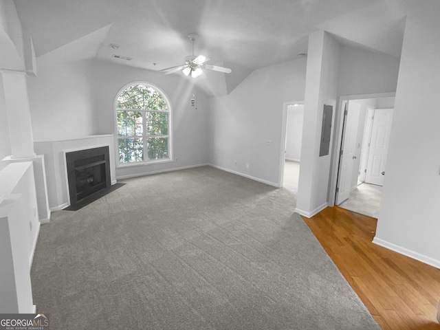 4279 Orchard Grv, Stone Mountain, GA 30083 - unfurnished living room featuring lofted ceiling, ceiling fan, a fireplace with flush hearth, wood finished floors, and carpet floors