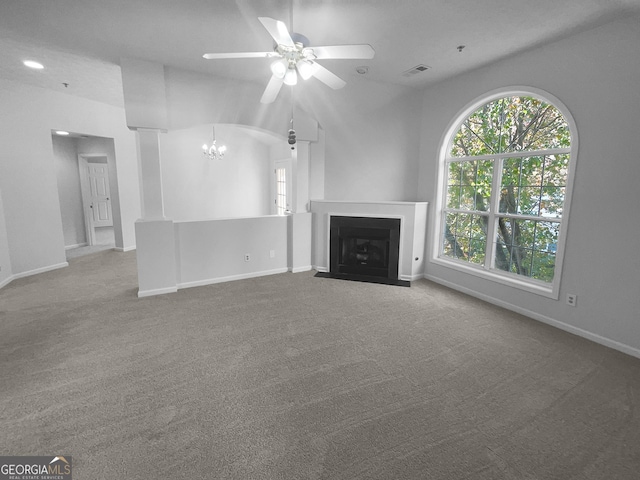 unfurnished living room with carpet flooring, plenty of natural light, and lofted ceiling