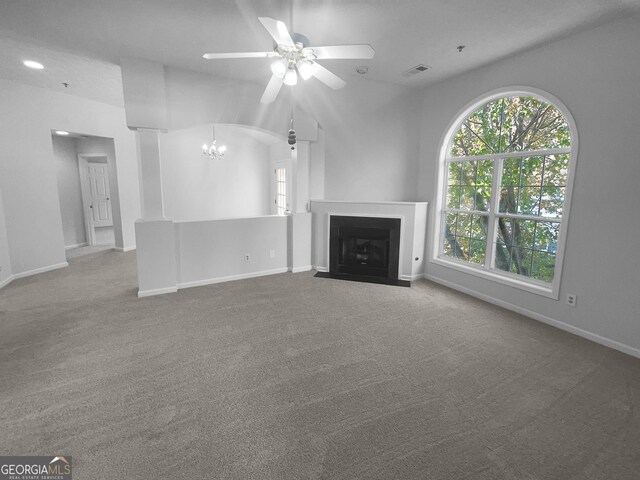 4279 Orchard Grv, Stone Mountain, GA 30083 - unfurnished living room with ceiling fan, a chandelier, healthy amount of natural light, carpet flooring, and vaulted ceiling