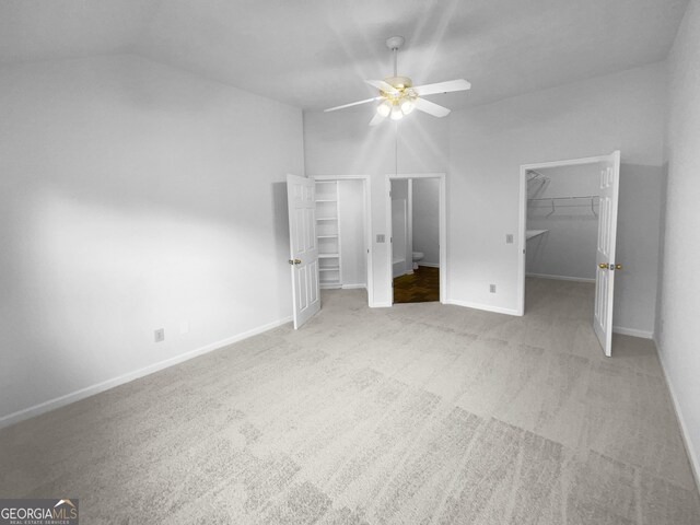 4279 Orchard Grv, Stone Mountain, GA 30083 - unfurnished bedroom with a walk in closet, carpet, lofted ceiling, a closet, and a ceiling fan