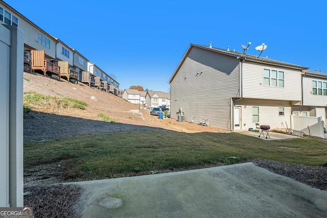 back of house featuring a patio area and a lawn