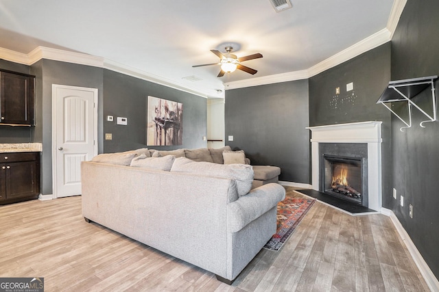 living room featuring light hardwood / wood-style floors and crown molding