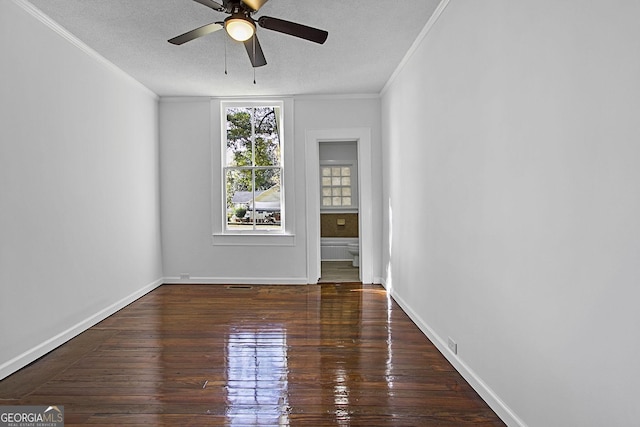 unfurnished room with crown molding, ceiling fan, dark wood-type flooring, and a textured ceiling