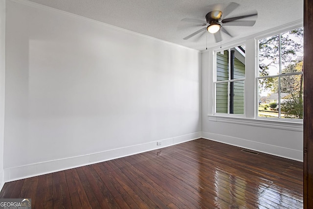 spare room featuring a textured ceiling, dark hardwood / wood-style floors, ceiling fan, and ornamental molding