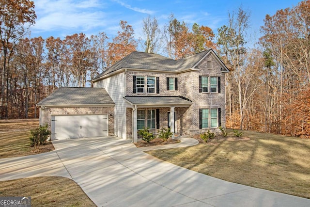 view of front facade with a front yard and a garage