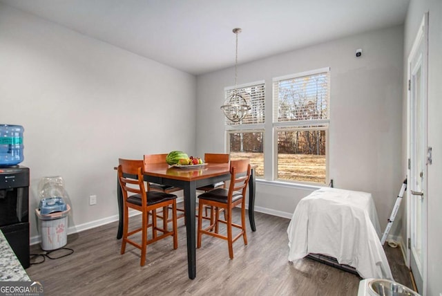 dining room featuring hardwood / wood-style floors, plenty of natural light, and an inviting chandelier