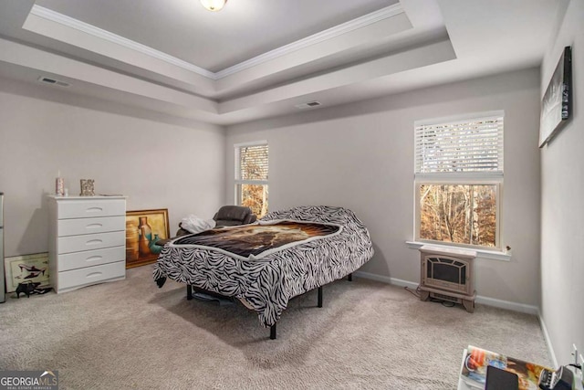 carpeted bedroom featuring a raised ceiling and ornamental molding