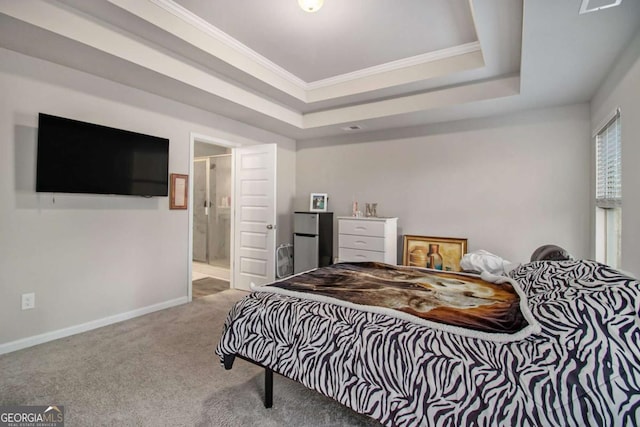 bedroom with carpet, a raised ceiling, crown molding, and ensuite bath