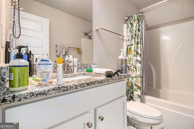 full bathroom with vanity, shower / tub combo, and toilet