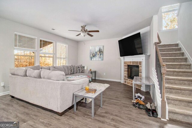 living room featuring ceiling fan, plenty of natural light, and hardwood / wood-style flooring