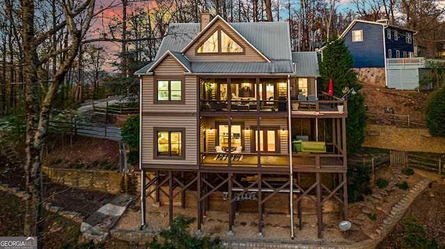 view of back house at dusk