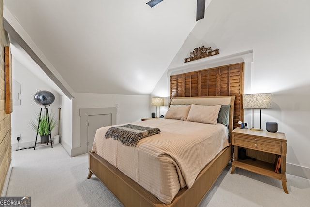 carpeted bedroom with lofted ceiling