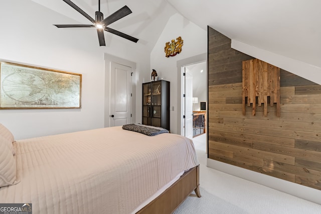 bedroom featuring high vaulted ceiling, ceiling fan, light carpet, and wooden walls