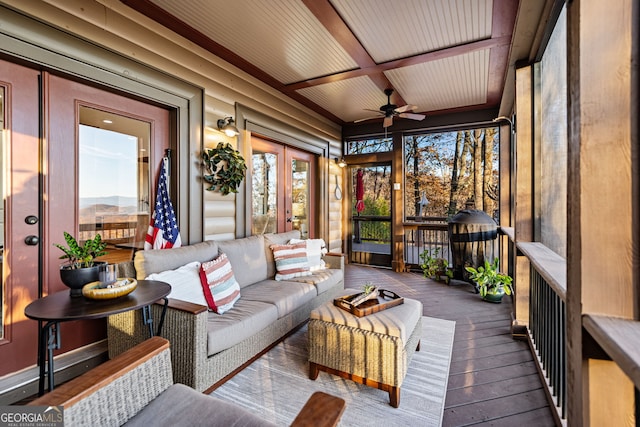 sunroom / solarium featuring ceiling fan