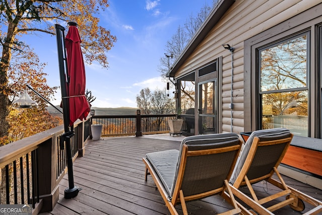 wooden deck featuring a sunroom