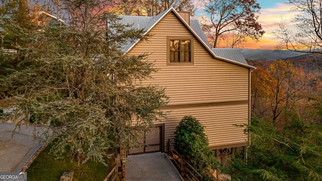 property exterior at dusk featuring a mountain view